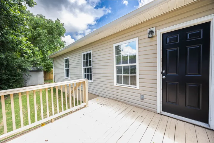 A spacious wooden deck provides an inviting outdoor area for relaxation and entertaining.