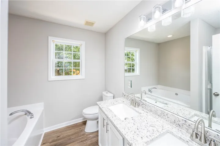 The bathroom was updated with new flooring, new lighting, counters, sinks, fixtures and commode.