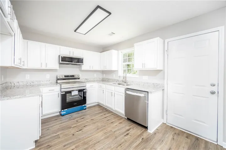 This kitchen has new counters, new flooring, new appliances, lighting and fixtures.