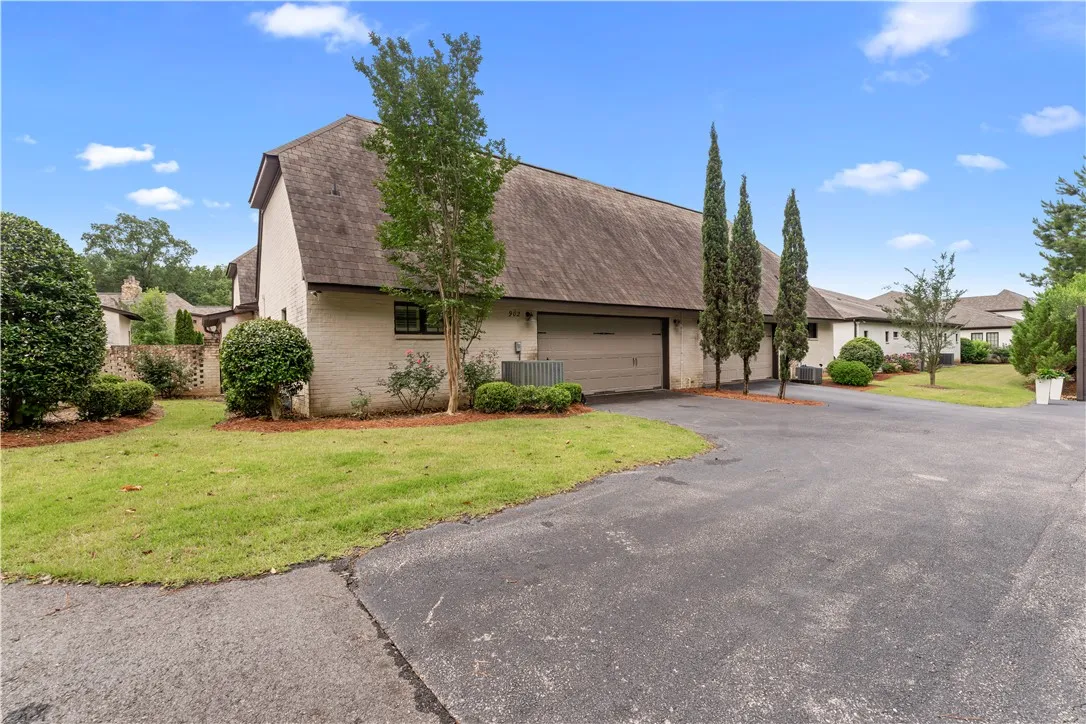 A neatly maintained lawn and mature landscaping enhance this inviting property's curb appeal.