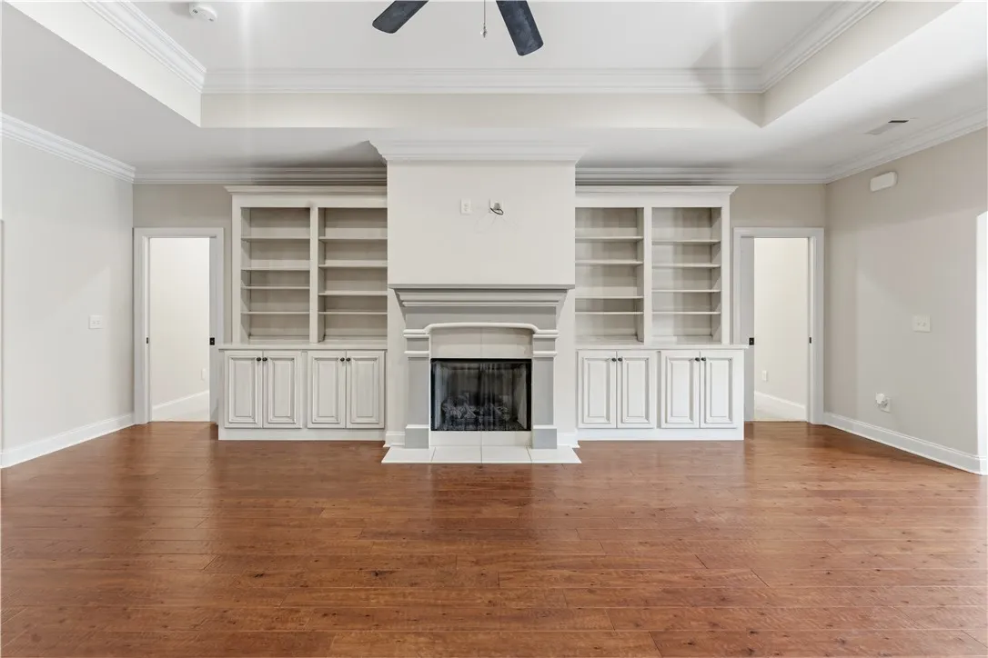 Built-in bookcases flank a charming fireplace in this warm and inviting living area.