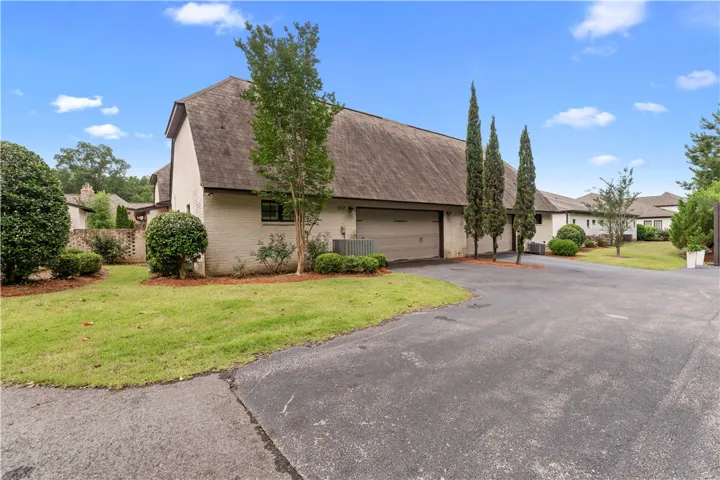 A neatly maintained lawn and mature landscaping enhance this inviting property's curb appeal.