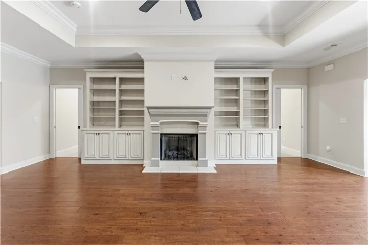 Built-in bookcases flank a charming fireplace in this warm and inviting living area.