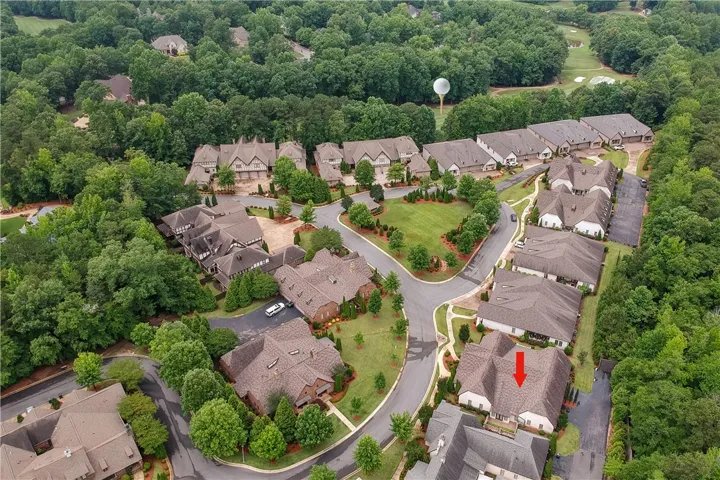 An aerial perspective reveals a master-planned community nestled amidst lush, verdant landscapes, complete with a golf course.