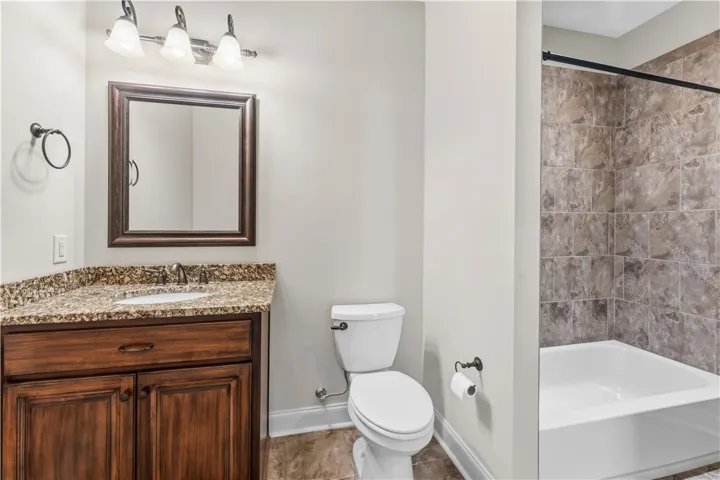 A well-appointed bathroom with a spacious vanity and a combination shower/tub.