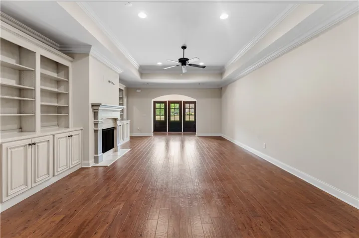 Hardwood floors and a cozy fireplace create a warm and inviting atmosphere in this generous living space.