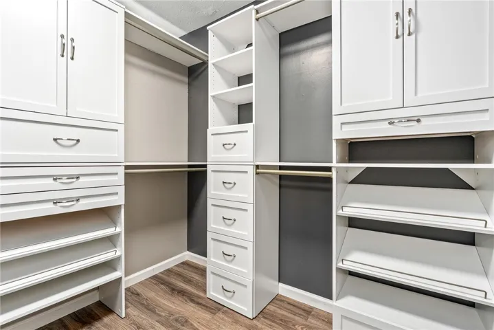 Customized organization awaits in this well-appointed walk-in closet, complete with ample storage solutions.