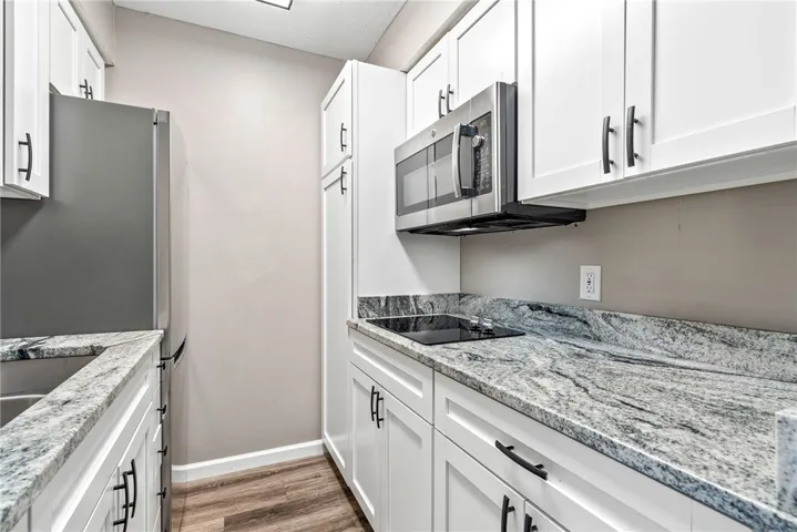 Modern kitchen with sleek countertops and integrated stainless steel appliances.