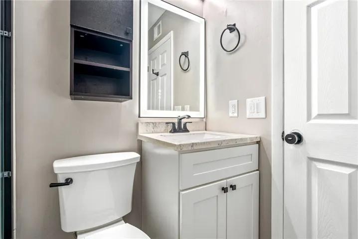 A compact and functional bathroom vanity, offering practical storage and a sleek, contemporary design.