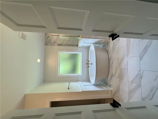 Sleek lines and modern fixtures create a calming sanctuary in this well-appointed bath.