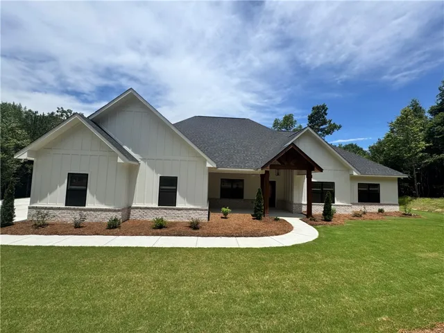 An inviting front entry welcomes you to this modern farmhouse with tasteful stone accents.