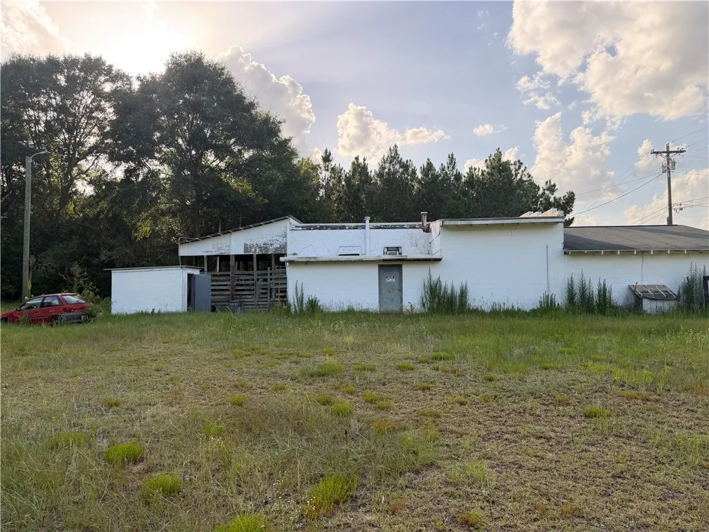 A promising commercial lot awaits, boasting ample space for development with existing structures.