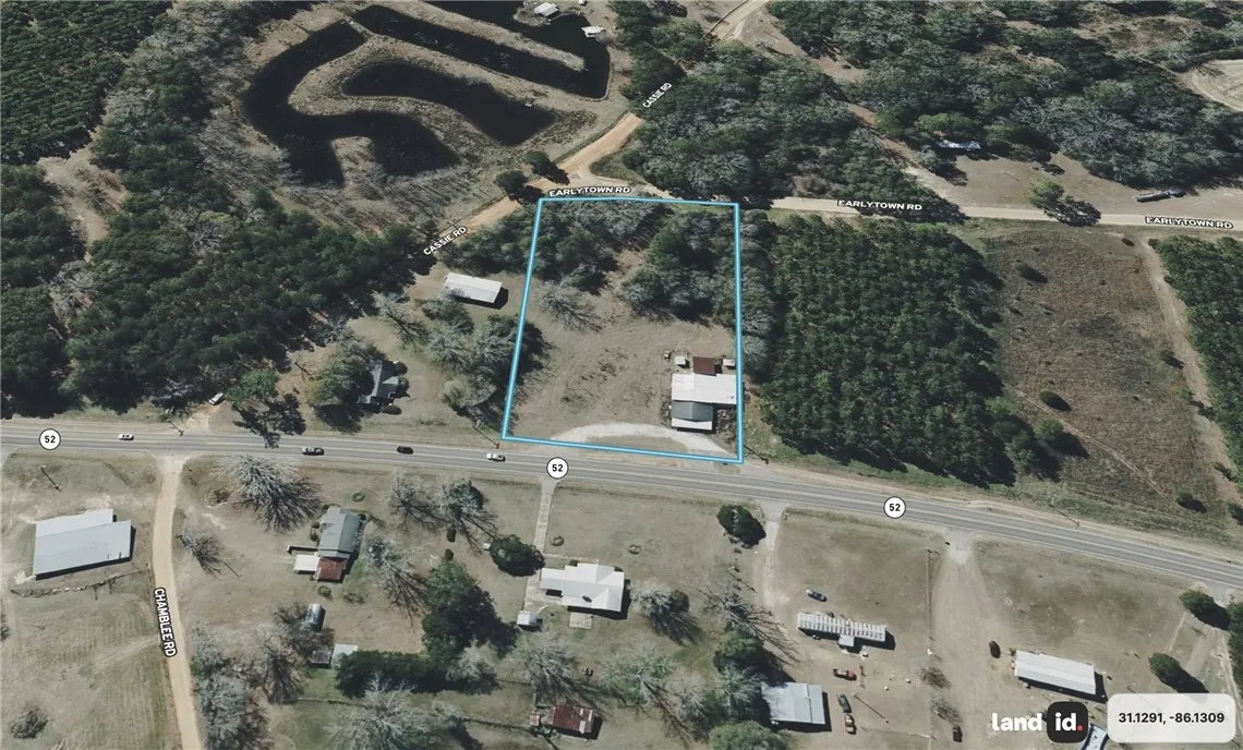 An aerial perspective reveals a prime corner lot featuring extensive road frontage, ideal for diverse development.