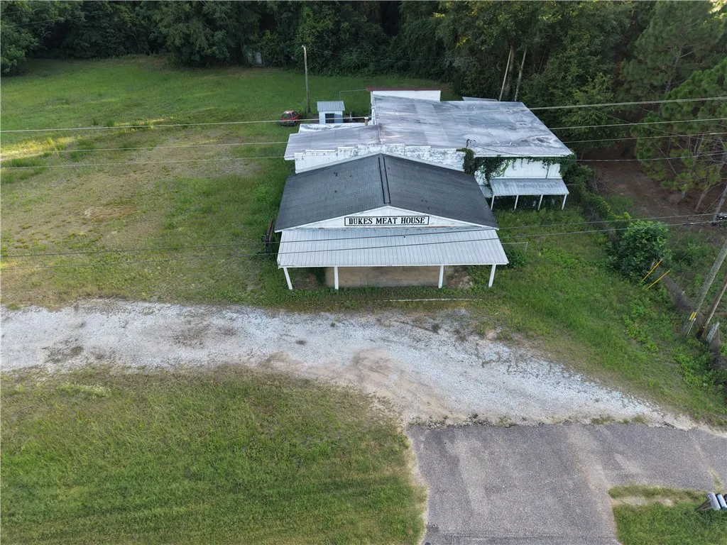 A promising commercial structure on a spacious lot with abundant green space awaits its next chapter.