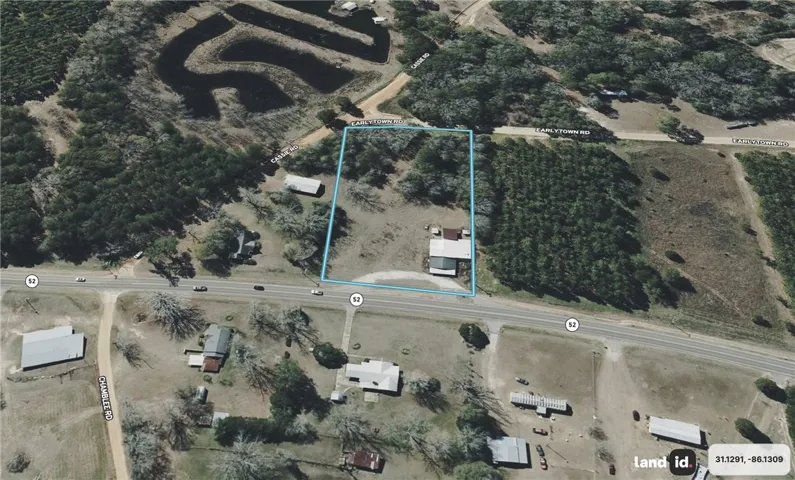 An aerial perspective reveals a prime corner lot featuring extensive road frontage, ideal for diverse development.
