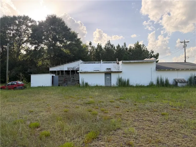 A promising commercial lot awaits, boasting ample space for development with existing structures.