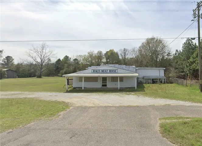 A promising commercial property with a broad front for prime visibility, awaiting a revitalizing touch.