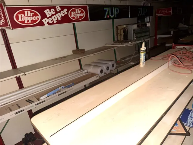 An empty retail space with shelving and counter areas awaits a new business vision.