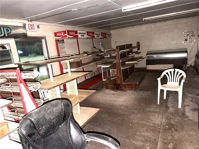 A commercial space offering extensive display shelving and potential for retail operations.