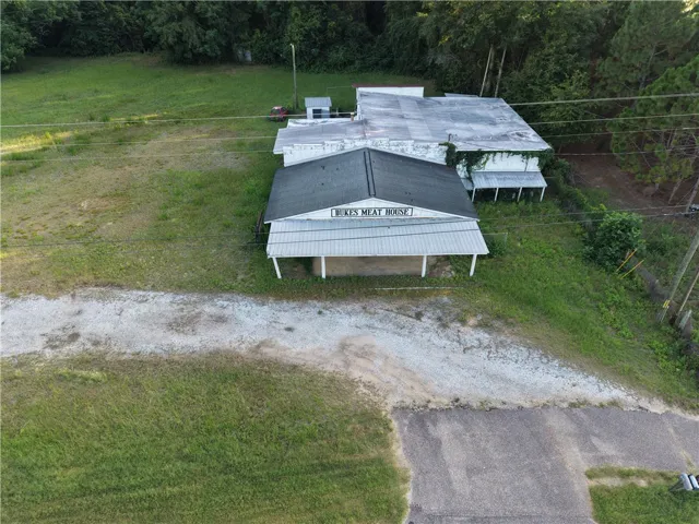 A promising commercial structure on a spacious lot with abundant green space awaits its next chapter.