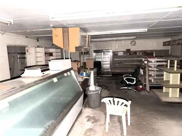 An empty retail space with concrete flooring awaits a new vision.