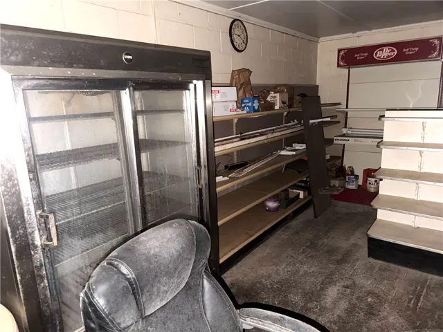 A commercial cooler and extensive shelving offer practical storage solutions for any business.