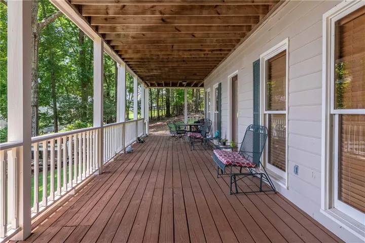 A spacious covered porch offers an ideal setting for relaxation amidst natural surroundings.