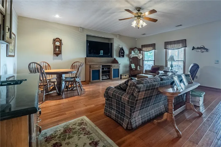 Warm wood flooring extends throughout this inviting living space, complete with ample natural light.