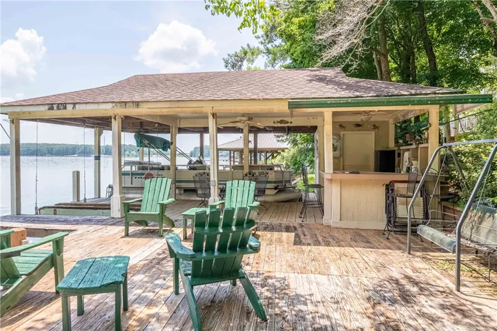 Boathouse with a private dock and a covered outdoor entertaining space on the water.