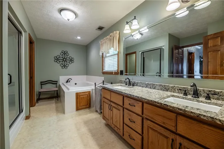 Relax in the deep soaking tub or prepare for your day at the generously sized double vanity with granite counters.