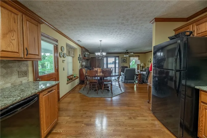 Hardwood floors and an open concept layout define this inviting living and dining space with water views.