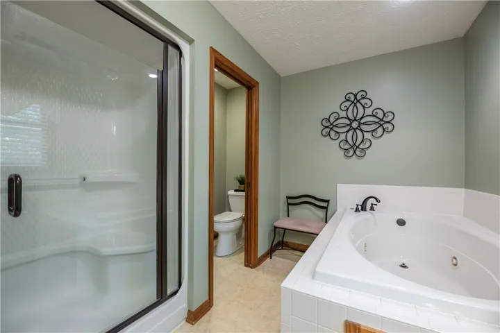 Indulge in a tranquil bathing experience with a jetted tub and a separate, convenient shower.