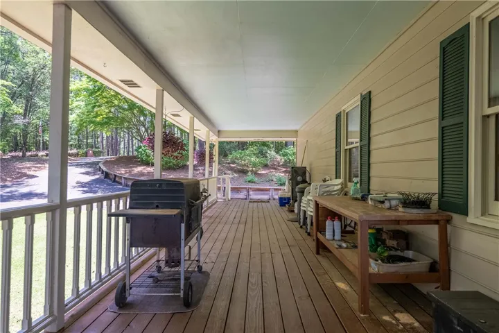 A spacious covered deck extends the living space outdoors, offering serene views of the surrounding natural landscape.