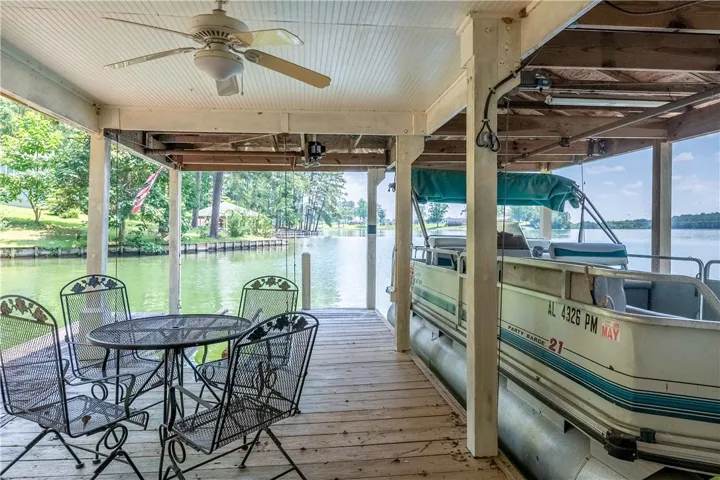 Boathouse with covered deck provides a picturesque lakeside retreat.