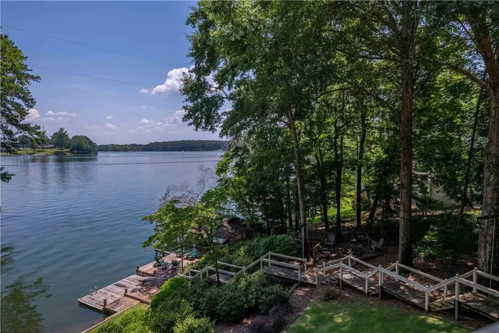 Relax on the dock, enjoying direct access to the lake, surrounded by lush, mature trees.