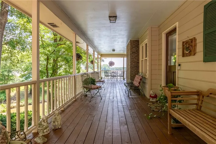 A spacious, covered porch offers serene outdoor living with ample room for entertaining and scenic views.