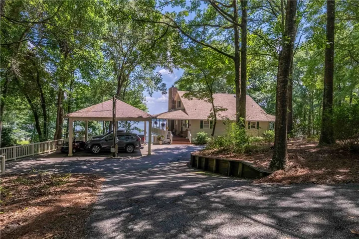 A charming lakeside dwelling, nestled among mature trees, offers a private and serene retreat.