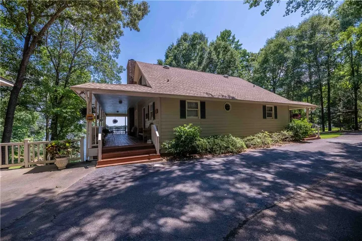 Enjoy water views from this charming lakeside dwelling with a welcoming covered porch.