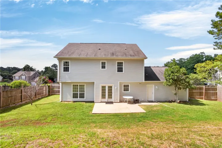 A spacious backyard with a patio offers a comfortable outdoor living experience.