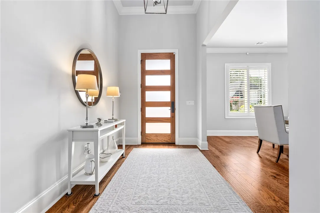 The impressive 11-foot foyer provides a beautiful first impression of the home's light-filled, refined interiors.
