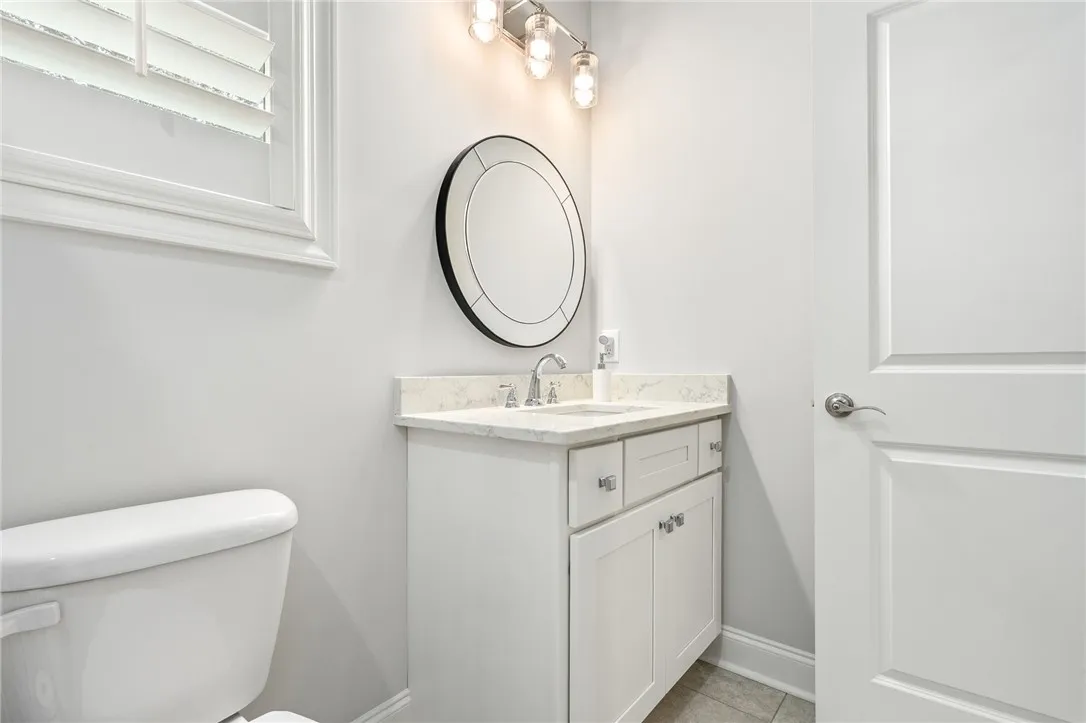 The tasteful second-floor bath serves the bedroom and bonus room.