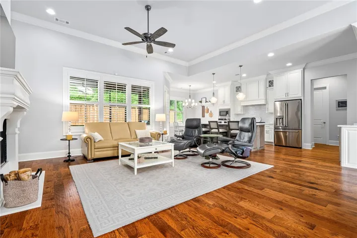 Designed for connection, the open floor plan seamlessly links the living room, kitchen, breakfast room, and screened porch into one inviting living space.
