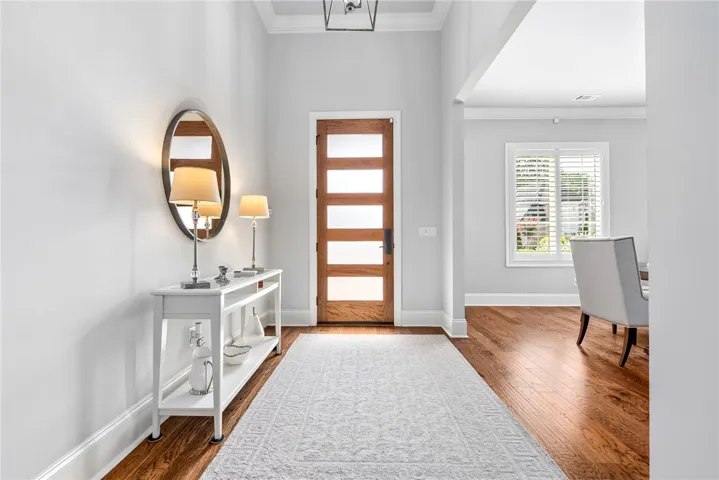 The impressive 11-foot foyer provides a beautiful first impression of the home's light-filled, refined interiors.