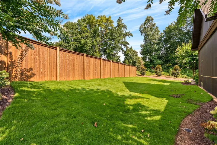 The spacious, fenced backyard provides a broad expanse of lush lawn, creating the perfect setting for recreation, gardening, or quiet relaxation.