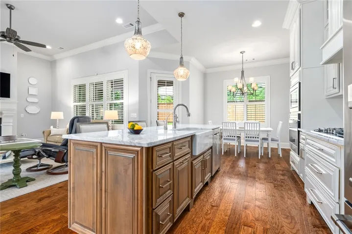 The marble-topped island provides generous workspace while beautifully defining the kitchen from the adjoining living areas.