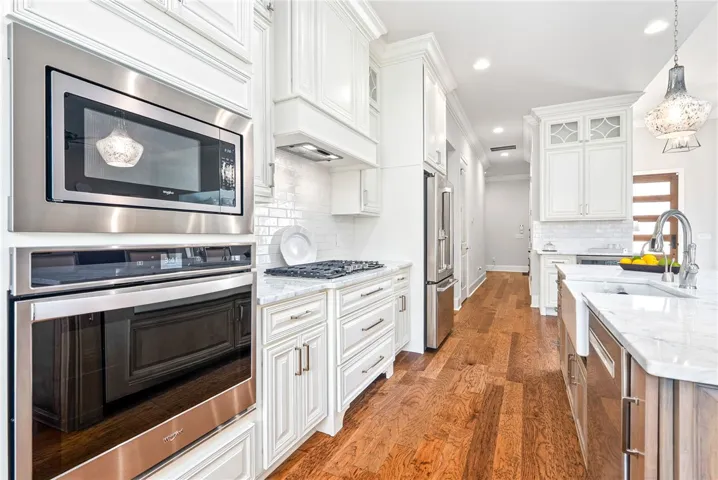 The hall beyong the kitchen leads to the owner's entry and laundry room.
