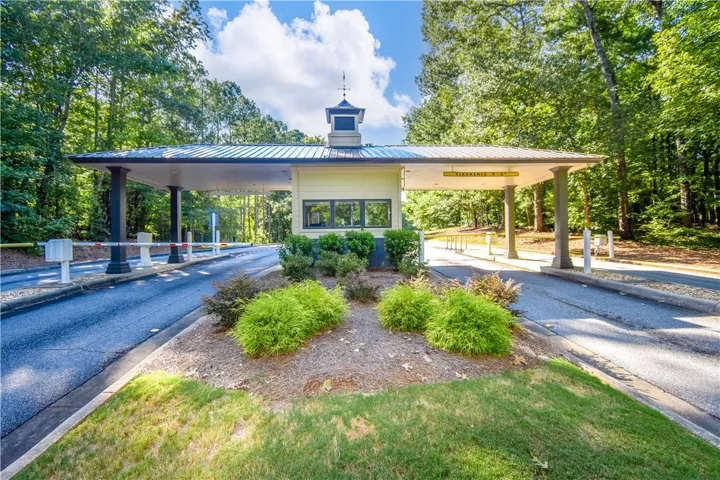 A well-maintained entry with a security booth welcomes residents to this verdant, private community.