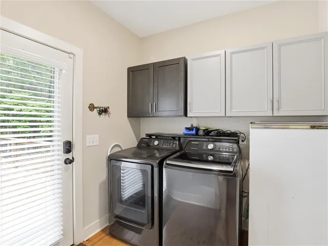 Functional laundry space featuring modern appliances and convenient outdoor access.