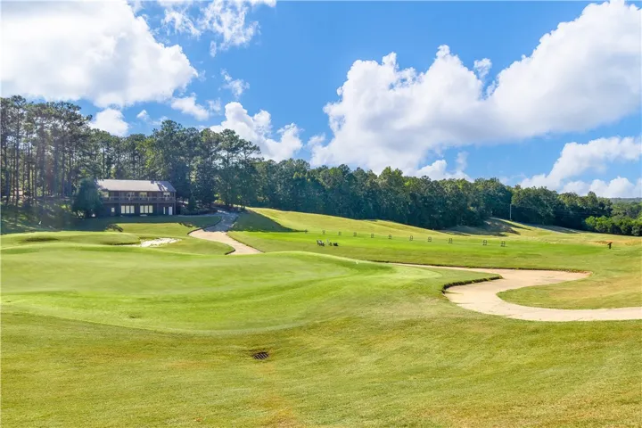 Green fairways and a charming building create a delightful golf course setting.
