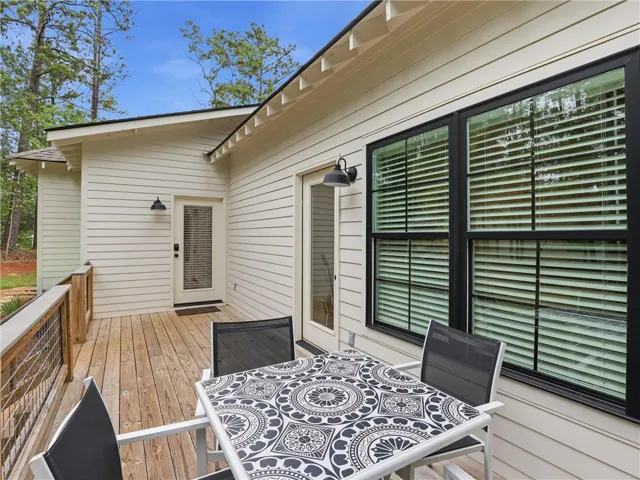 A spacious wooden deck provides ample outdoor living space, perfect for relaxing or entertaining.